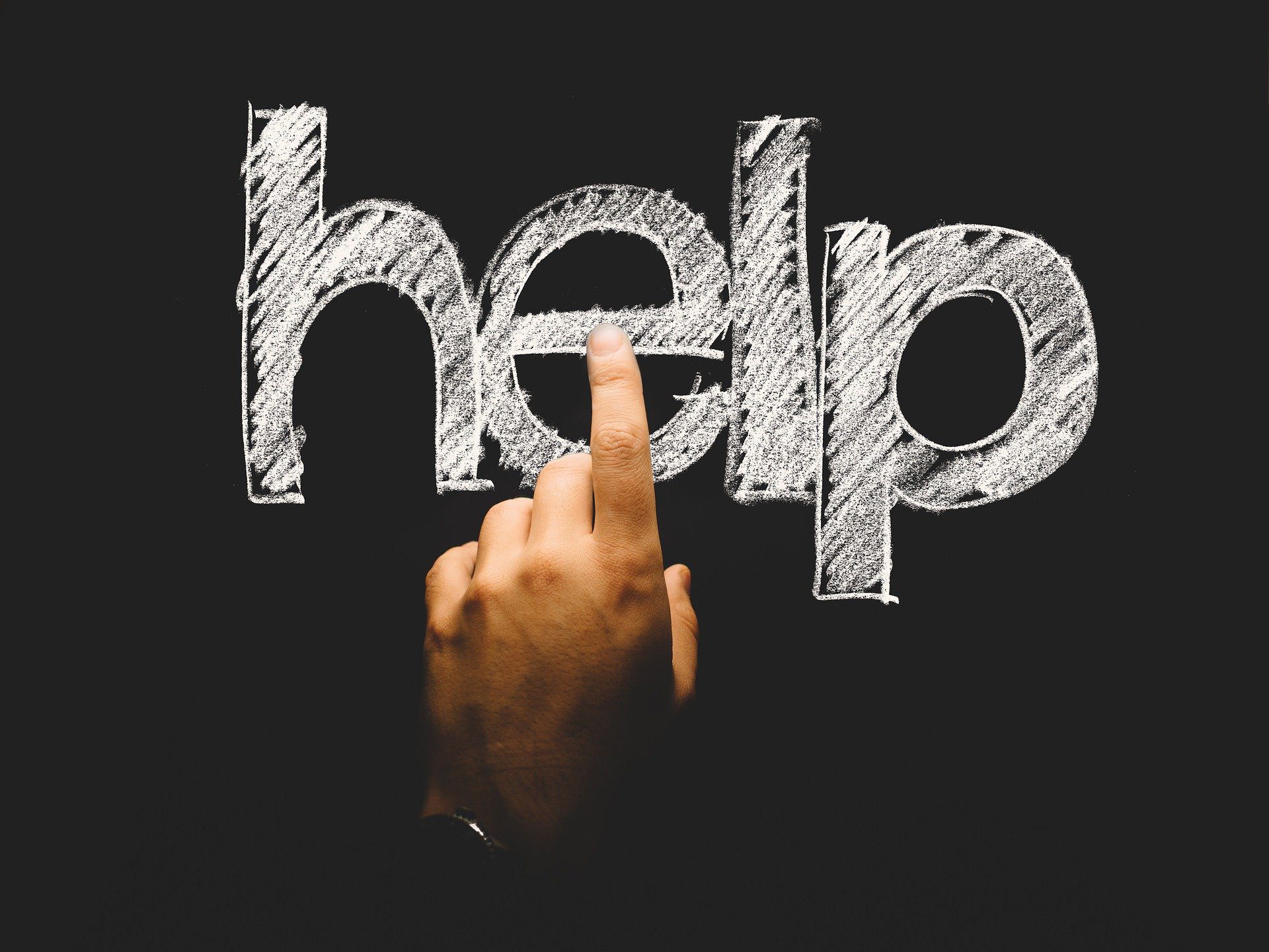 A blackboard with 'help' written on it