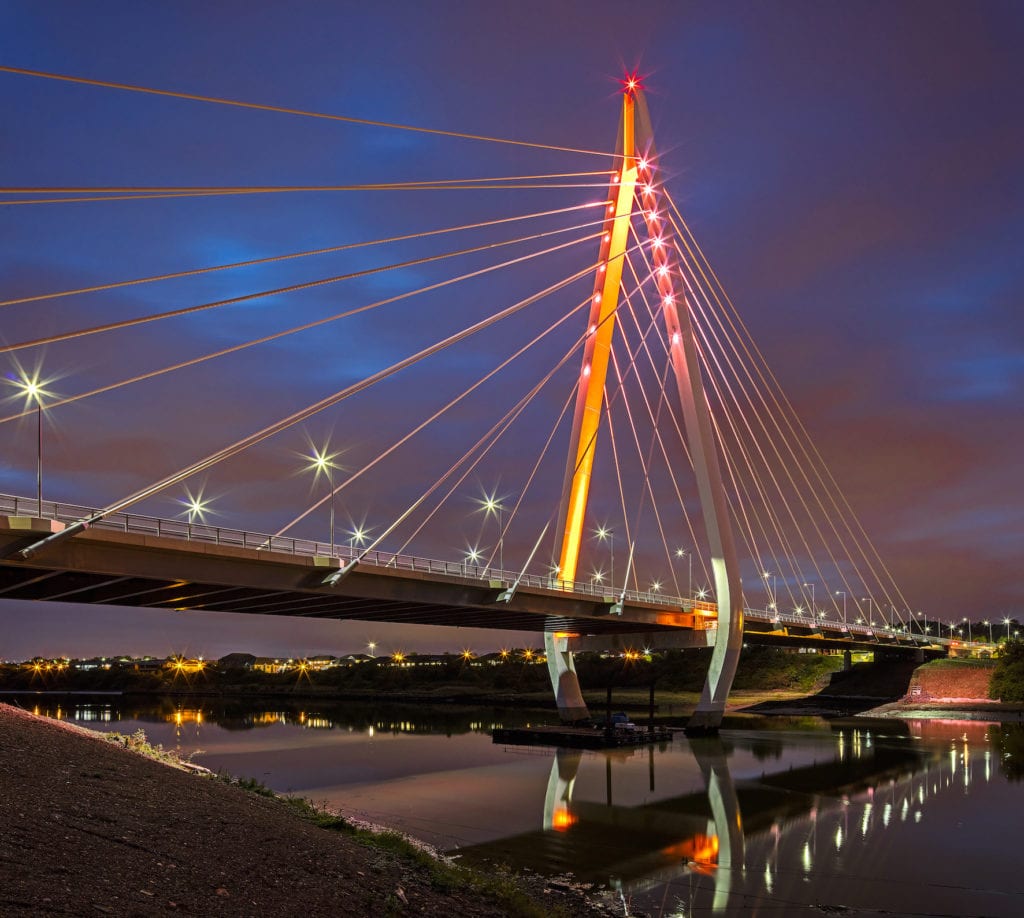 Photo of the Northern Spire Bridge illuminated at night