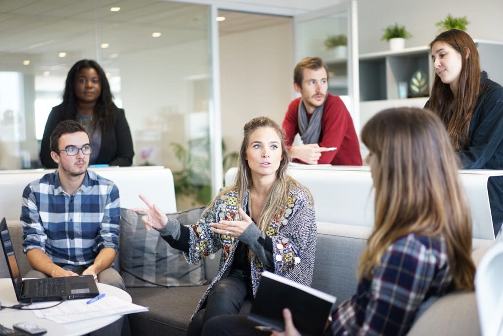 Photograph of people engaging in discussion in a team workshop setting